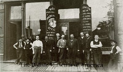 Polish immigrants standing in front of store
